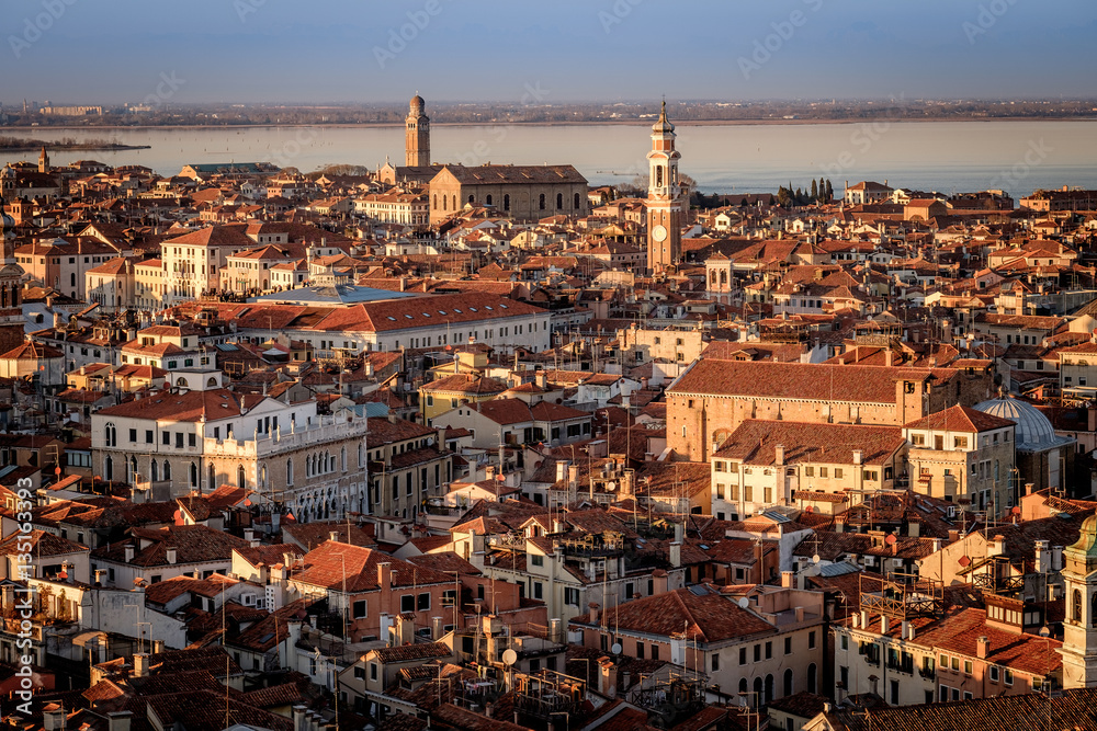 Panoramic aerial cityscape of Venice,with rooftops, the sea at sunset, Veneto, Italy.
