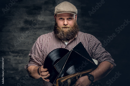 A man holds vinyl records.