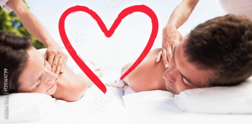 Composite image of happy couple back massage love hearts