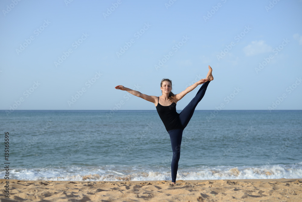 Woman is doing fitness, sunny blue sky sand beach outdoors background Woman is doing fitness, sunny blue sky sand beach outdoors background