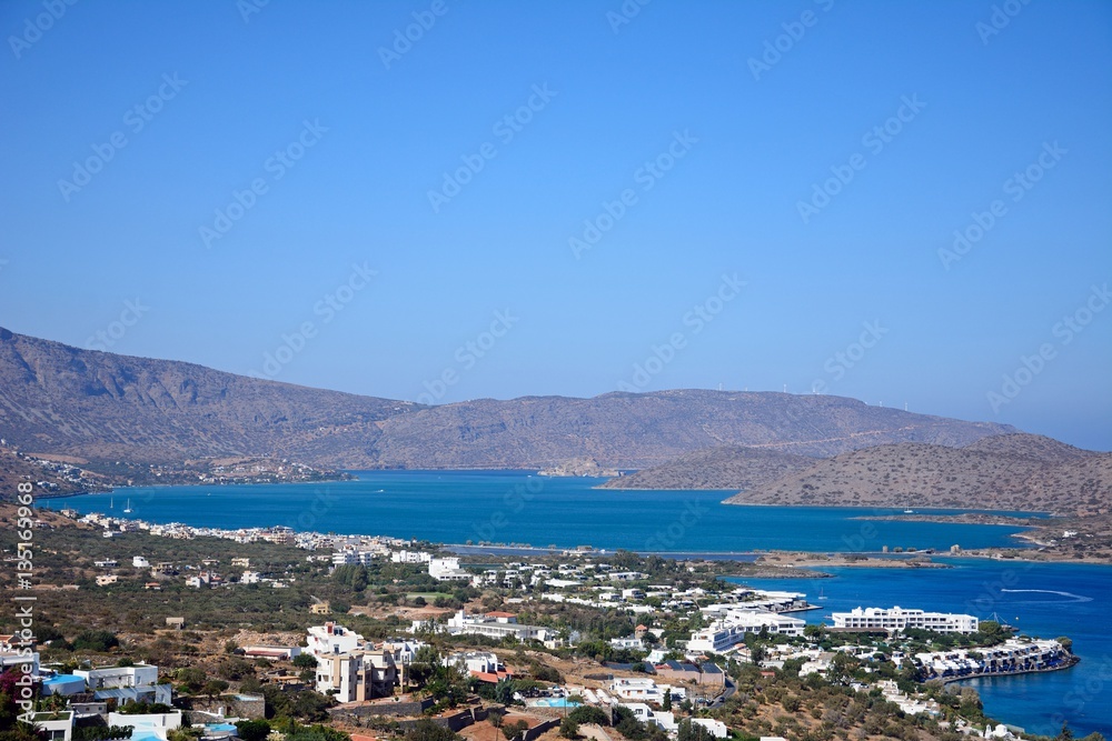Elevated view of Elounda with views across the sea towards the island of Spinalonga on the right hand side, Elounda, Crete.