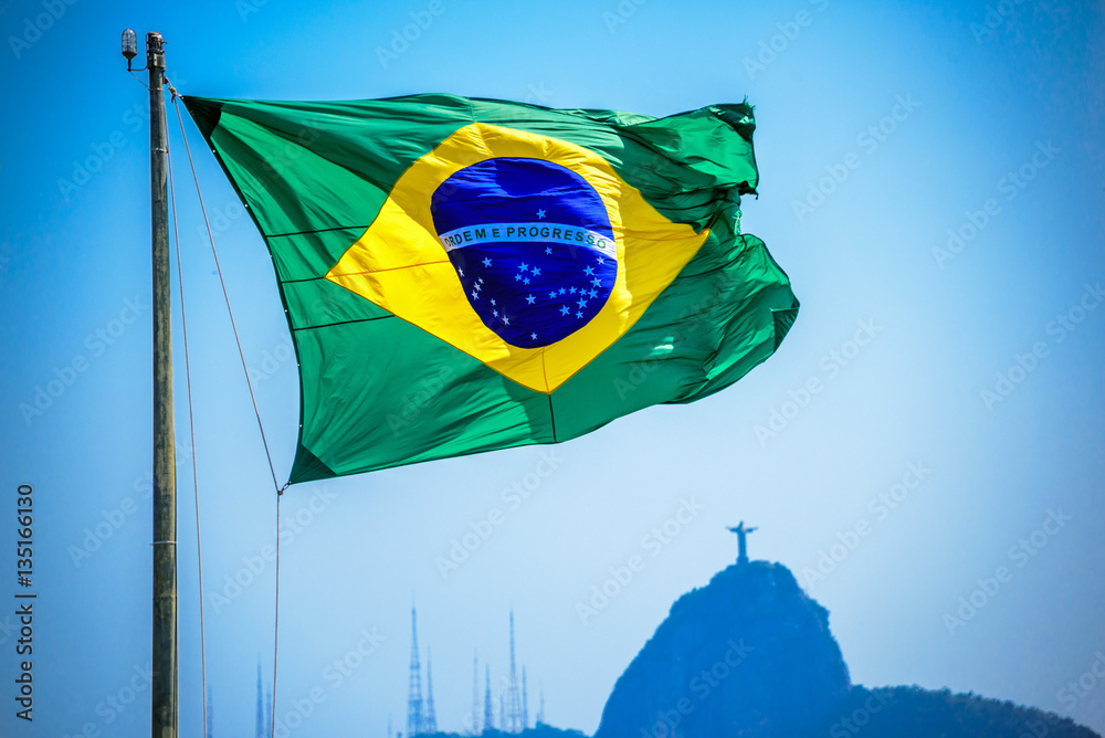 Brazilian flag on the background of Christ the Redeemer, Art Deco statue of  Jesus Christ in Rio de Janeiro, Brazil Stock Photo | Adobe Stock