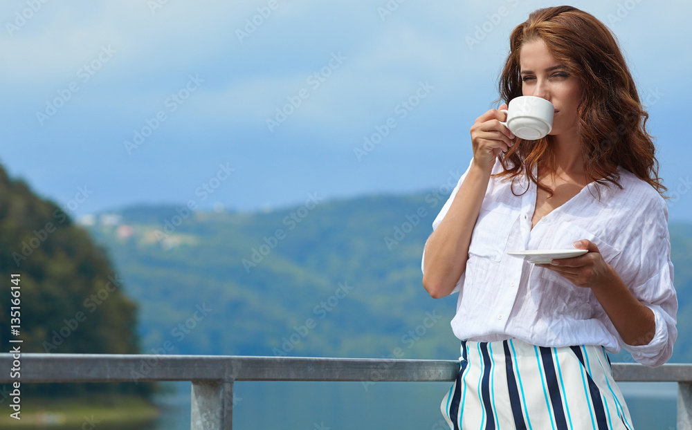 Beautiful woman relaxing on terrace house next lake background Beautiful woman relaxing on terrace house next lake background