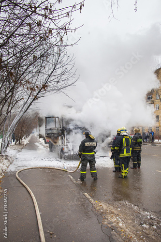 fire brigade extinguish a burning car