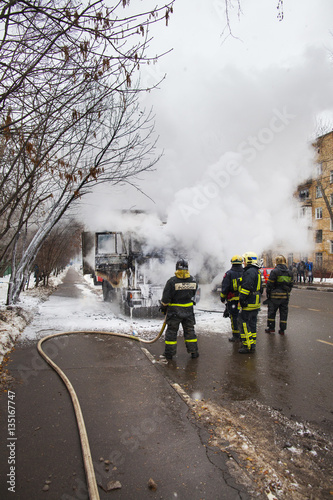 fire brigade extinguish a burning car