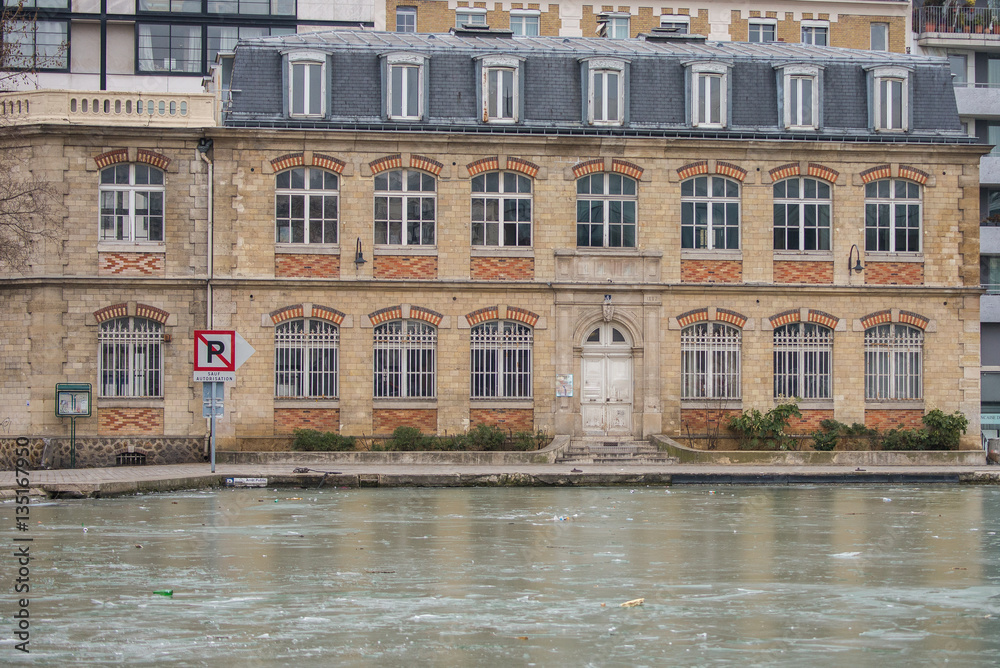 Paris, canal Saint-Martin, frozen channel on the quay in winter 