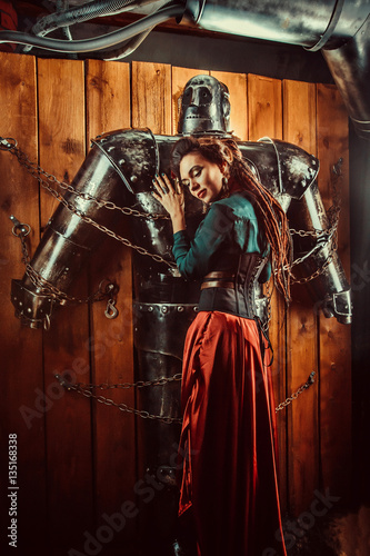 A beautiful woman with the tied male robot.