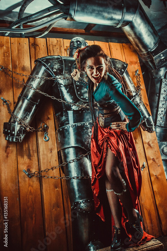 A beautiful woman with the tied male robot. © diter