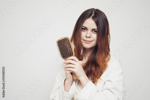 woman with a comb in his hand on a white background distressed hair