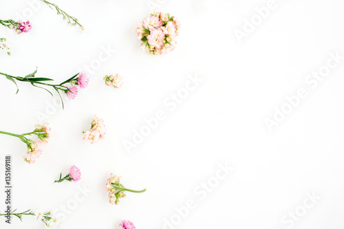 Floral background with pink and beige wildflowers, green leaves, branches on white background. Flat lay, top view. Valentine's background © Floral Deco