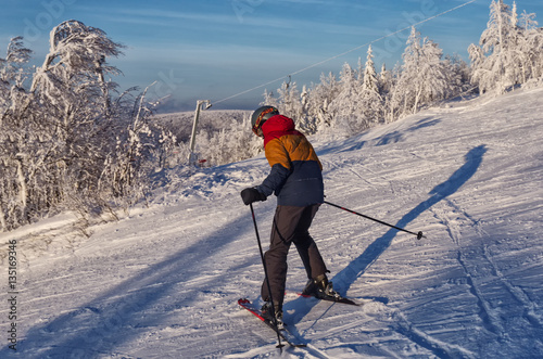 skier going down the slope at a ski resort