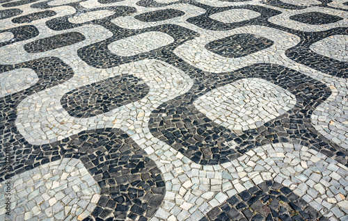 Black and white iconic mosaic, Portuguese pavement by old design pattern at Ipanema beach, Rio de Janeiro, Brazil