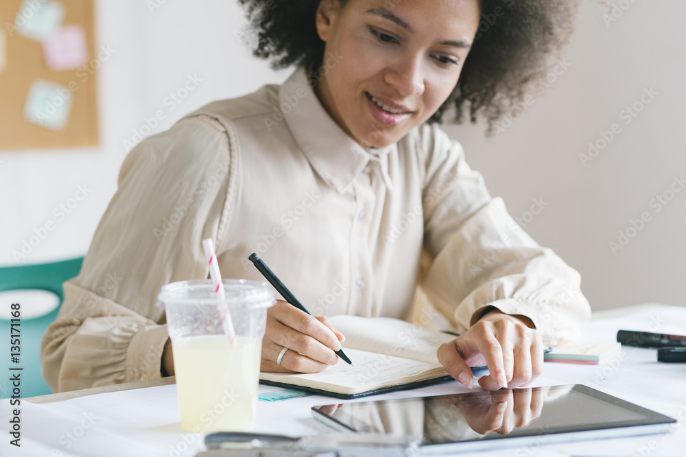Young smiling businesswoman working in her office Young smiling businesswoman working in her office