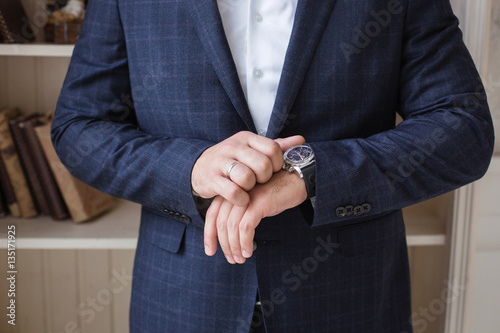 Man in blue suit, check your time, business, success. Selective focus
