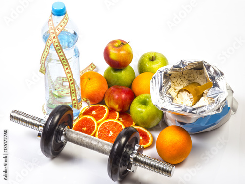 Concept of healthy active lifestyle. red oranges, apples, slices of red orange. Bottle with pure drinking water and ruler. Fitness dumbbell. Bag with whey vanilla protein with scoop.White background.