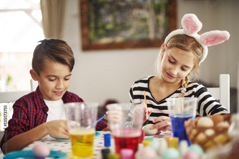 Fototapeta premium Elementary age kids painting eggs.