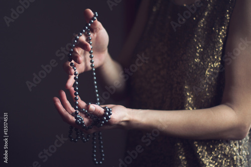 woman with pearls in her hands