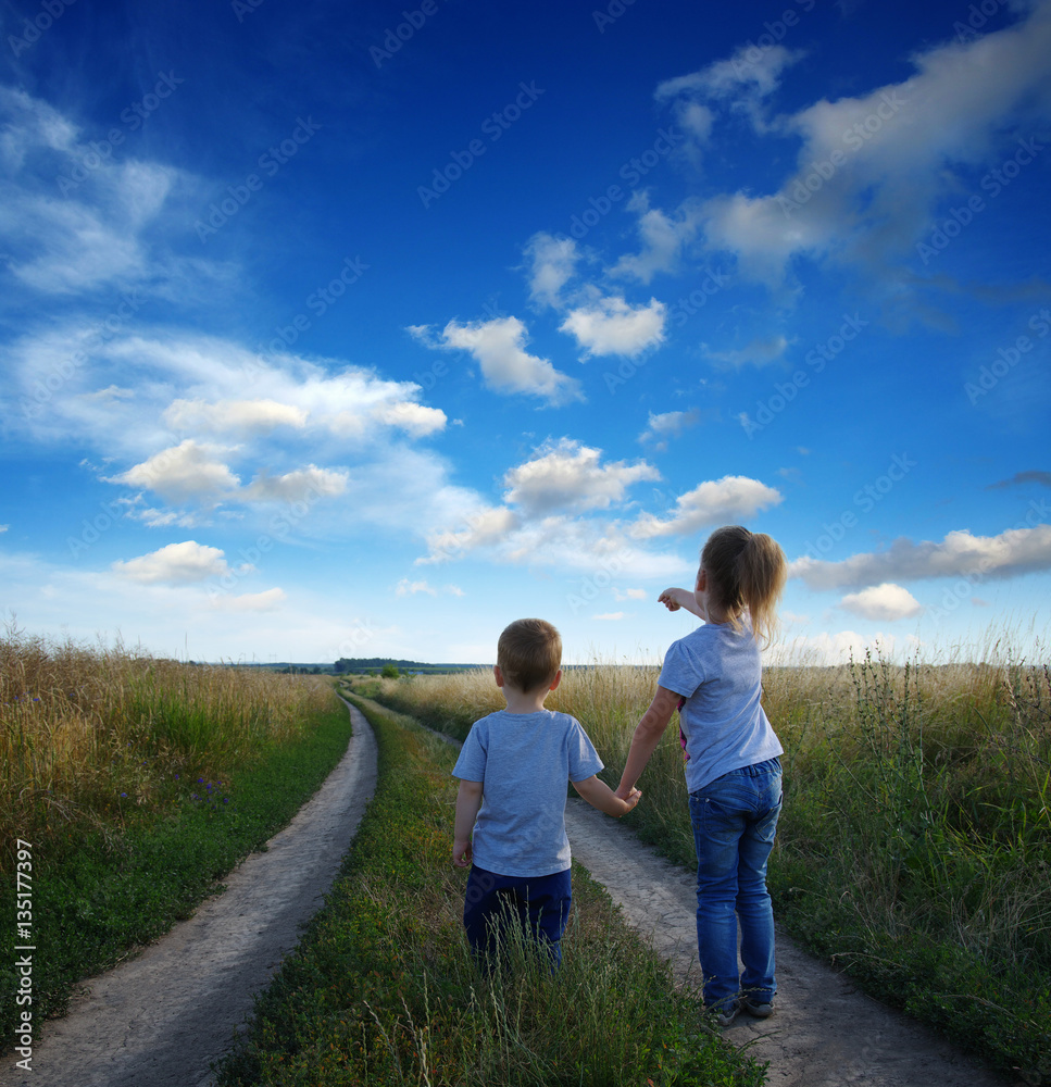 little boy and girl in the field