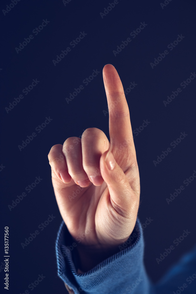 Businesswoman with raised index finger Businesswoman with raised index finger
