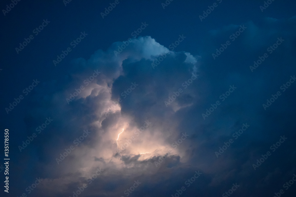Obraz premium Lightnings in storm clouds. Peals of a thunder and the sparkling lightnings in clouds
