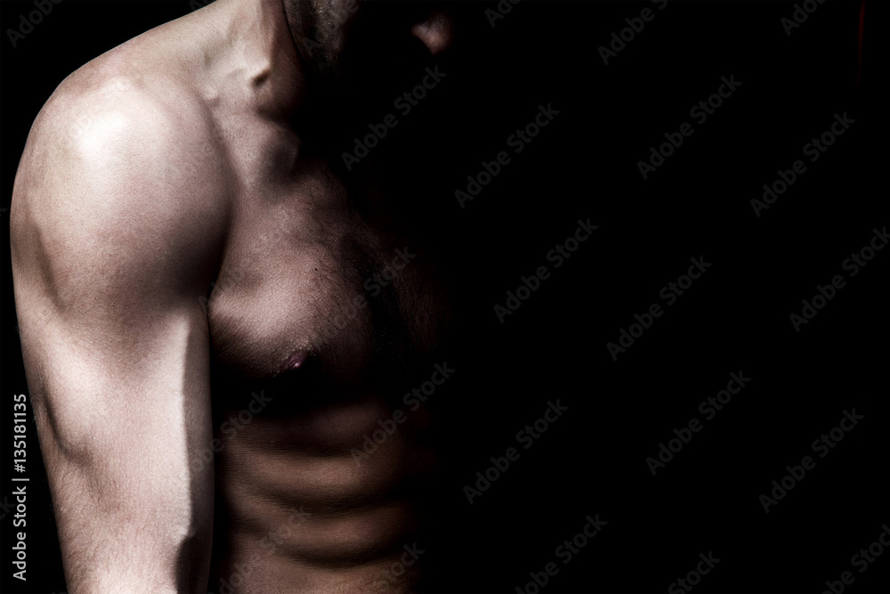 Naklejka premium Strong athletic man on black