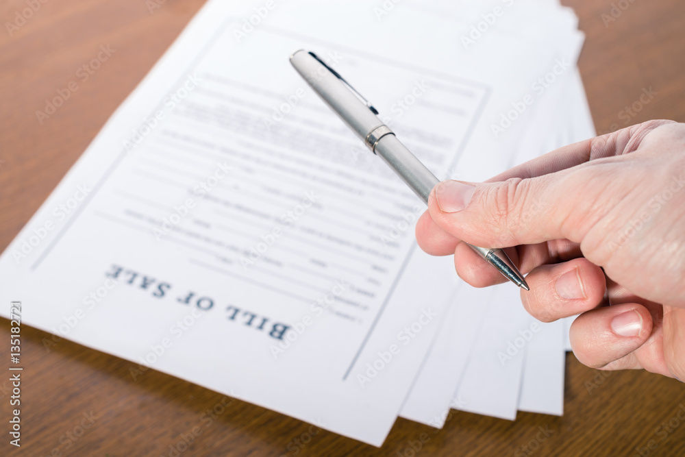 man's hand with a pen gives the pen for signing a contract man's hand with a pen gives the pen for signing a contract