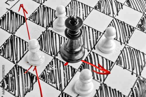 Chess. The black King is under attack. White board with chess figures on it. Helpmate or checkmate.