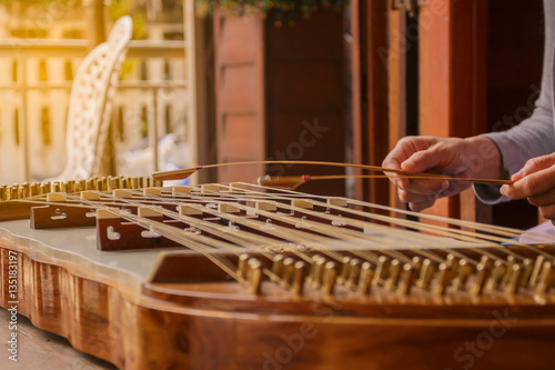 Closeup hand play hammered dulcimer.