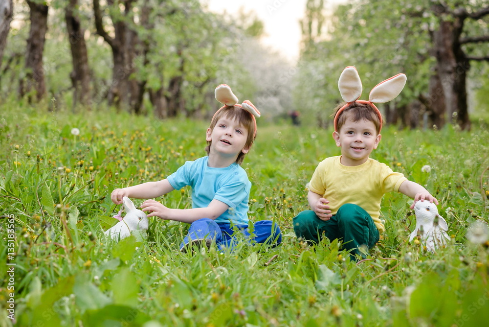 Two little kids boys and friends in Easter bunny ears during tra