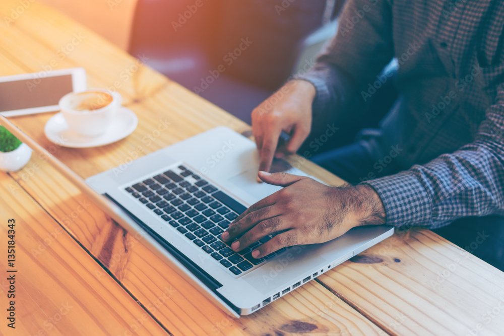 Hand of businessman using  laptop in coffee cafe