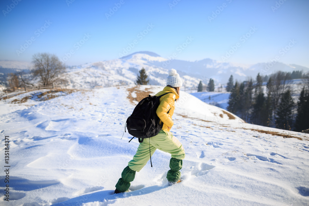Young woman hiking in winter mountains