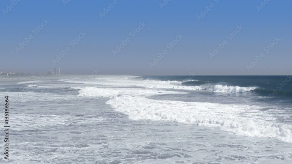 A view of the coastline of Huntington Beach, California after a storm triggers rough, foamy water formed after waves break along the shoreline.. A view of the coastline of Huntington Beach, California after a storm triggers rough, foamy water formed after waves break along the shoreline..