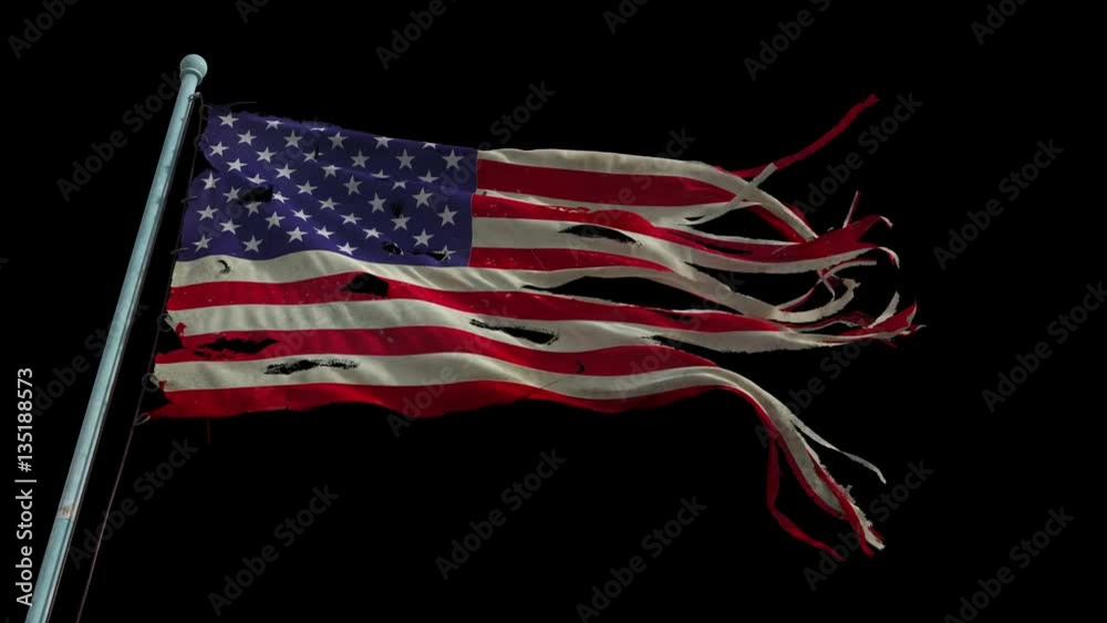 American torn and tattered flag waves in the wind. (Looped, with alpha channel)