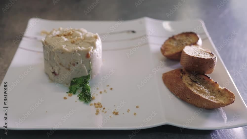 Chef Decorating Rabbit Pate With Toasted Baguette On a White Plate Chef Decorating Rabbit Pate With Toasted Baguette On a White Plate