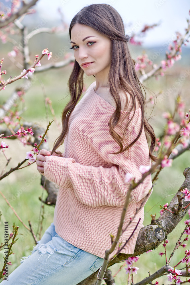 Fototapeta premium Beautiful woman in a spring garden