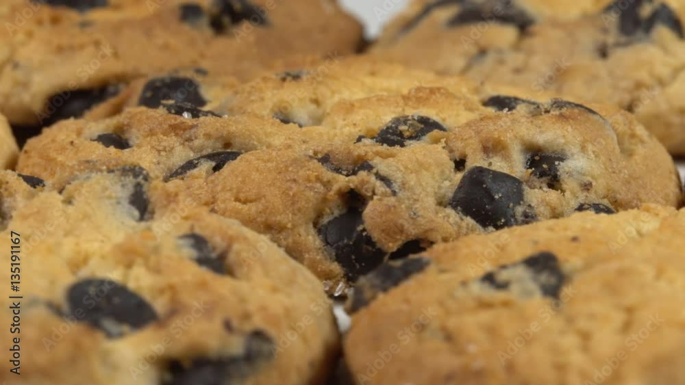 Biscuit Cookies with chocolate raisins rotates on a white table 4K Biscuit Cookies with chocolate raisins rotates on a white table 4K