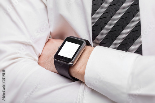 Mockup of crossed male hands with smart watch with blank screeb photo