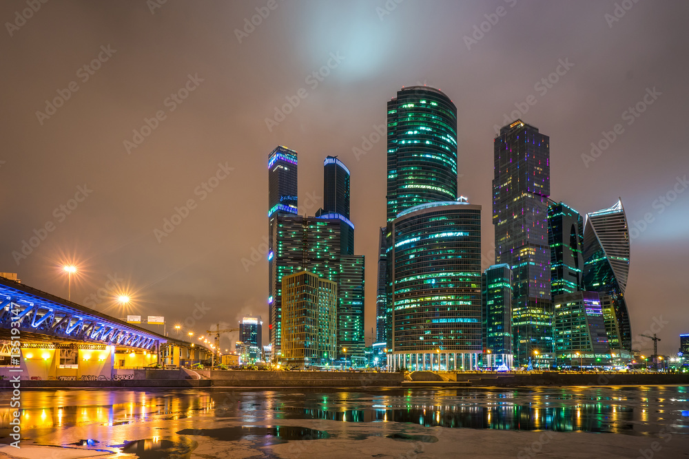 Panoramic night view on skyscrapers of the Moscow City International Business Center near river Moscow and Dorogomilovskiy bridge, Moscow, Russia. Panoramic night view on skyscrapers of the Moscow City International Business Center near river Moscow and Dorogomilovskiy bridge, Moscow, Russia.