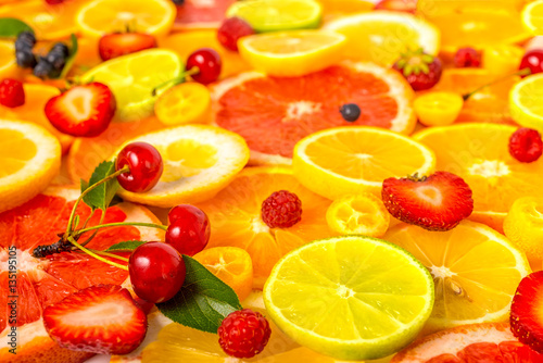 Fototapeta Naklejka Na Ścianę i Meble -  beautiful fresh sliced mixed citrus fruits as background with di