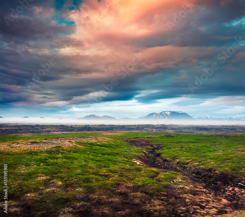 Typical Icelandic landscape with foggy mountains on the horizon. photo