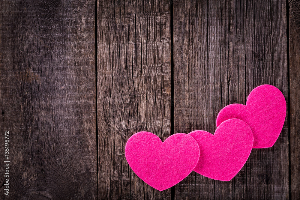 Three heart shapes on wooden table Three heart shapes on wooden table