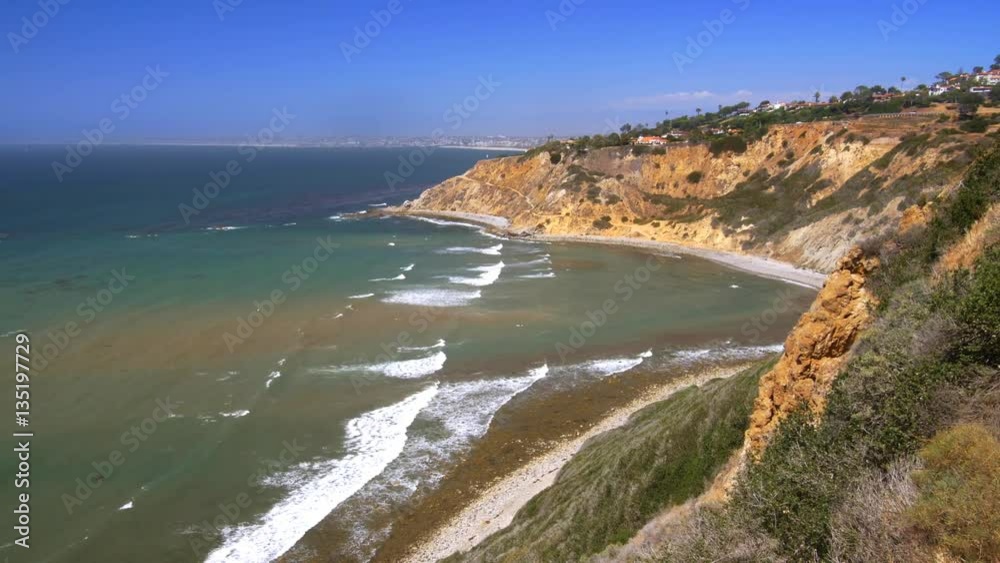 A cliffside view of a remote, colorful secluded cove in Palos Verdes California during a bright sunny day. A cliffside view of a remote, colorful secluded cove in Palos Verdes California during a bright sunny day.