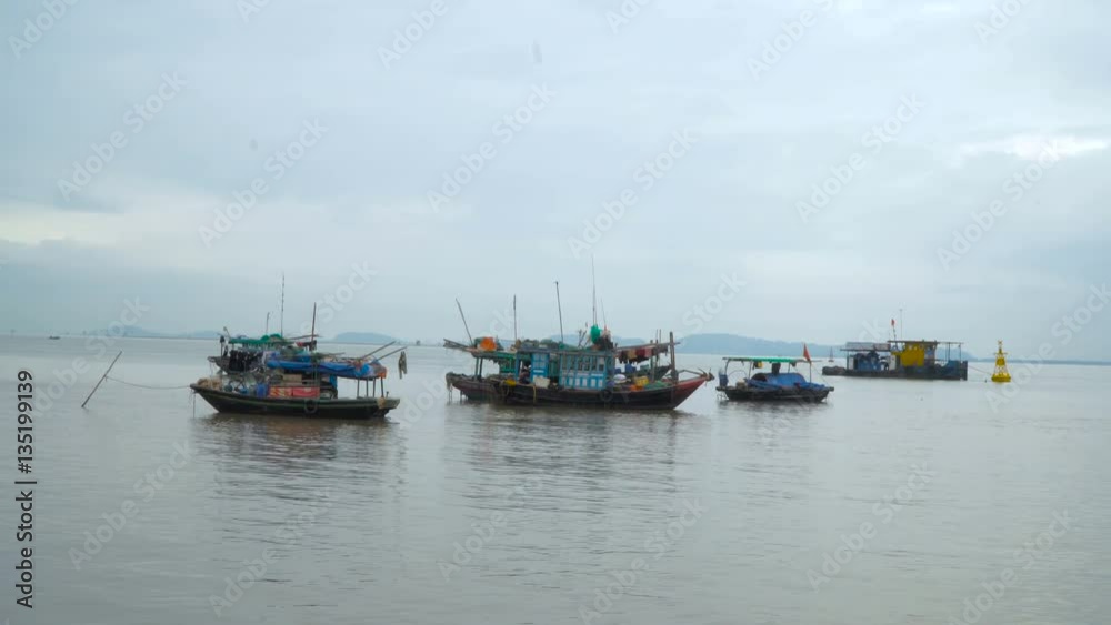 Group of traditional Vietnamese boats in the bay. Asian region. South China Sea. Vietnam travel landscape and destinations. Group of traditional Vietnamese boats in the bay. Asian region. South China Sea. Vietnam travel landscape and destinations.