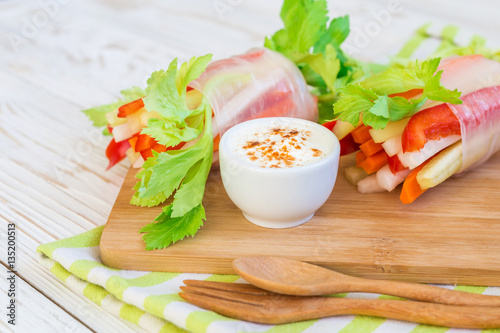 Spring roll with vegetables and white sour cream souce photo