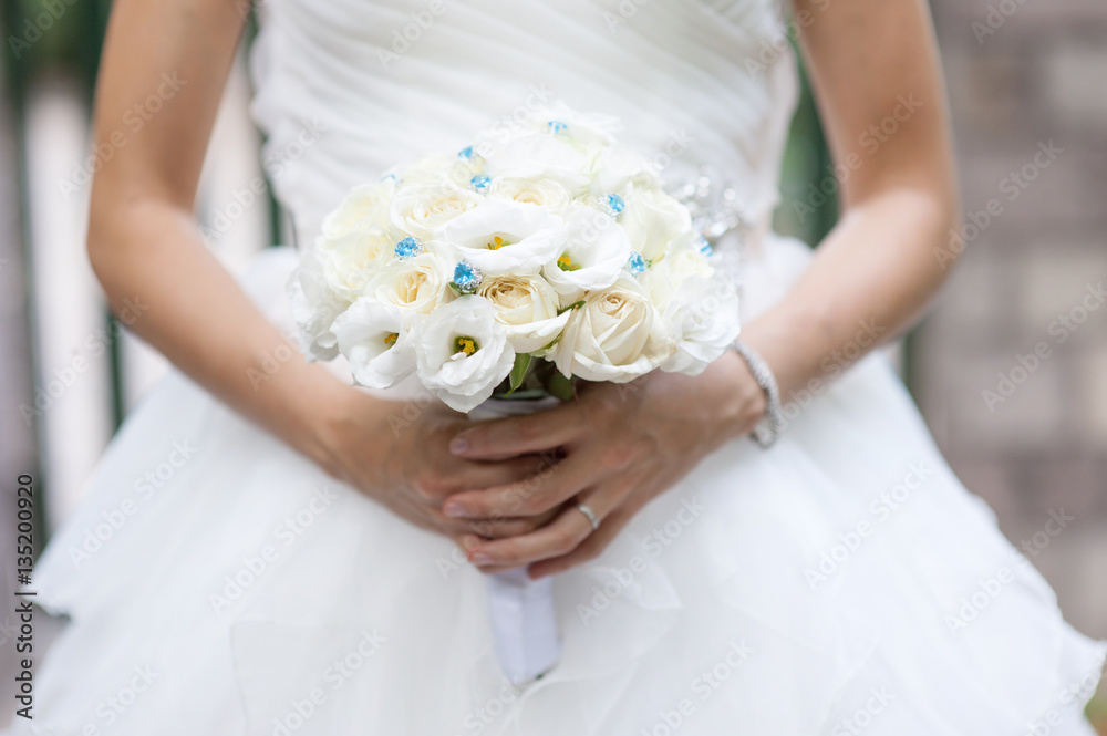 White roses wedding bouquet in bride's hand White roses wedding bouquet in bride's hand