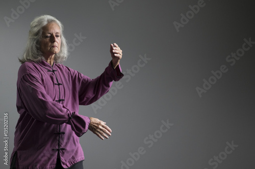 Quadro su tela A senior aged woman doing tai chi