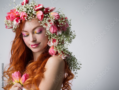 woman with red hair wearing a wreath of tulips © Evgenia Tiplyashina