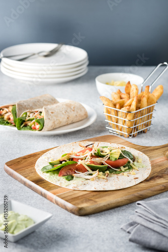 Fototapeta Naklejka Na Ścianę i Meble -  shredded barbecued chicken wraps with carrot, cheese, avocado an