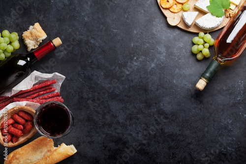 Red and white wine, grape, cheese and sausages © karandaev