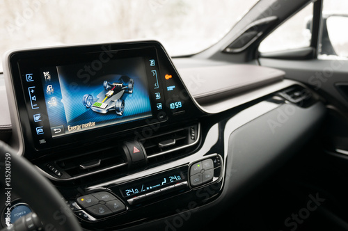 Hybrid car interior. Battery, electric motor and petrol engine working process.